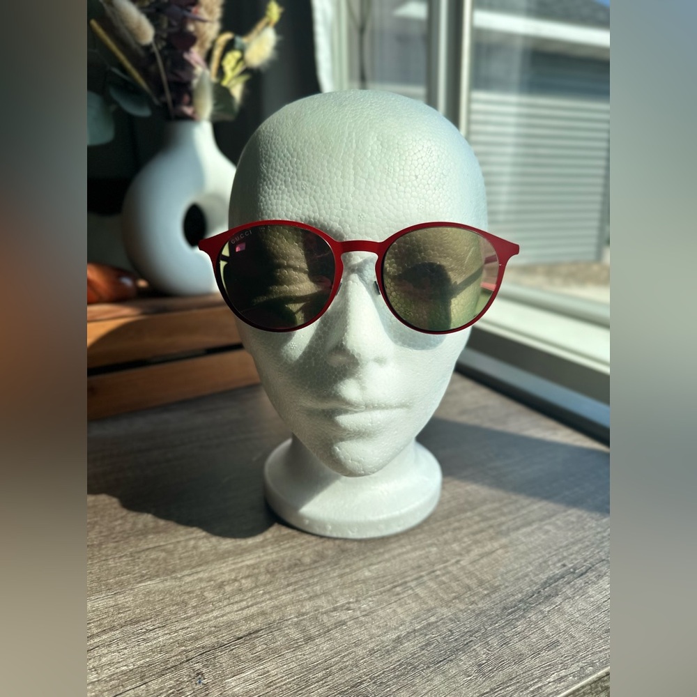 Gucci 52 mm round red framed sunglasses with red mirrored lenses.